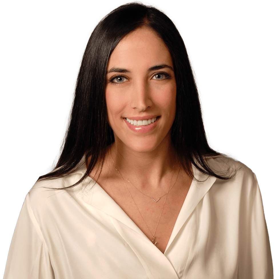 a smiling woman with clear skin in a white blouse